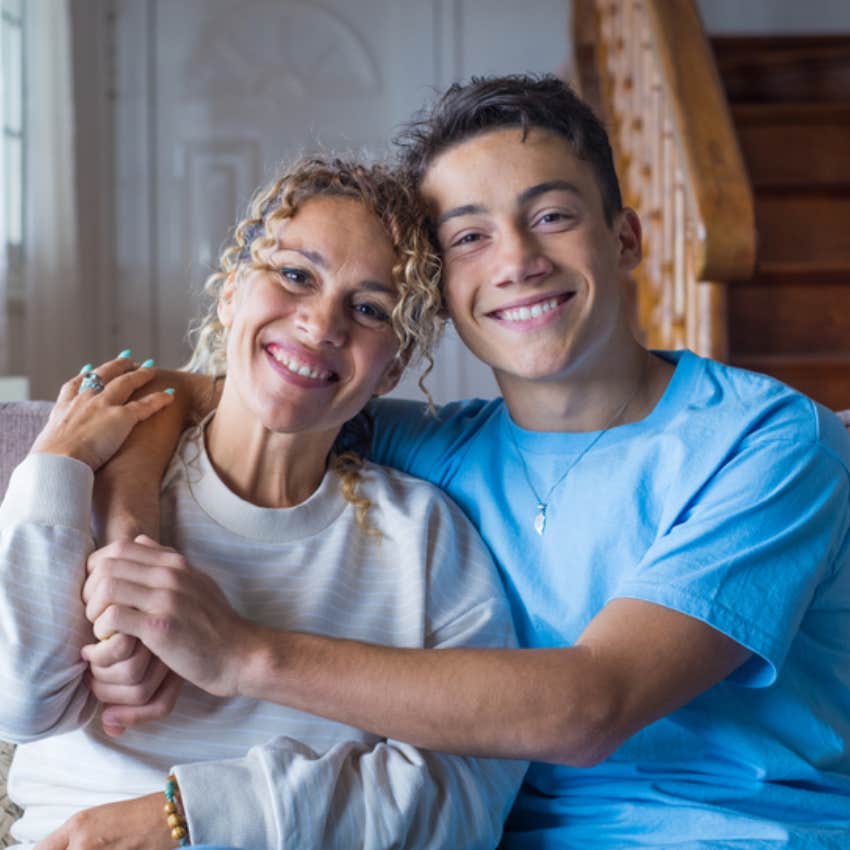 teenage son hugging mother 