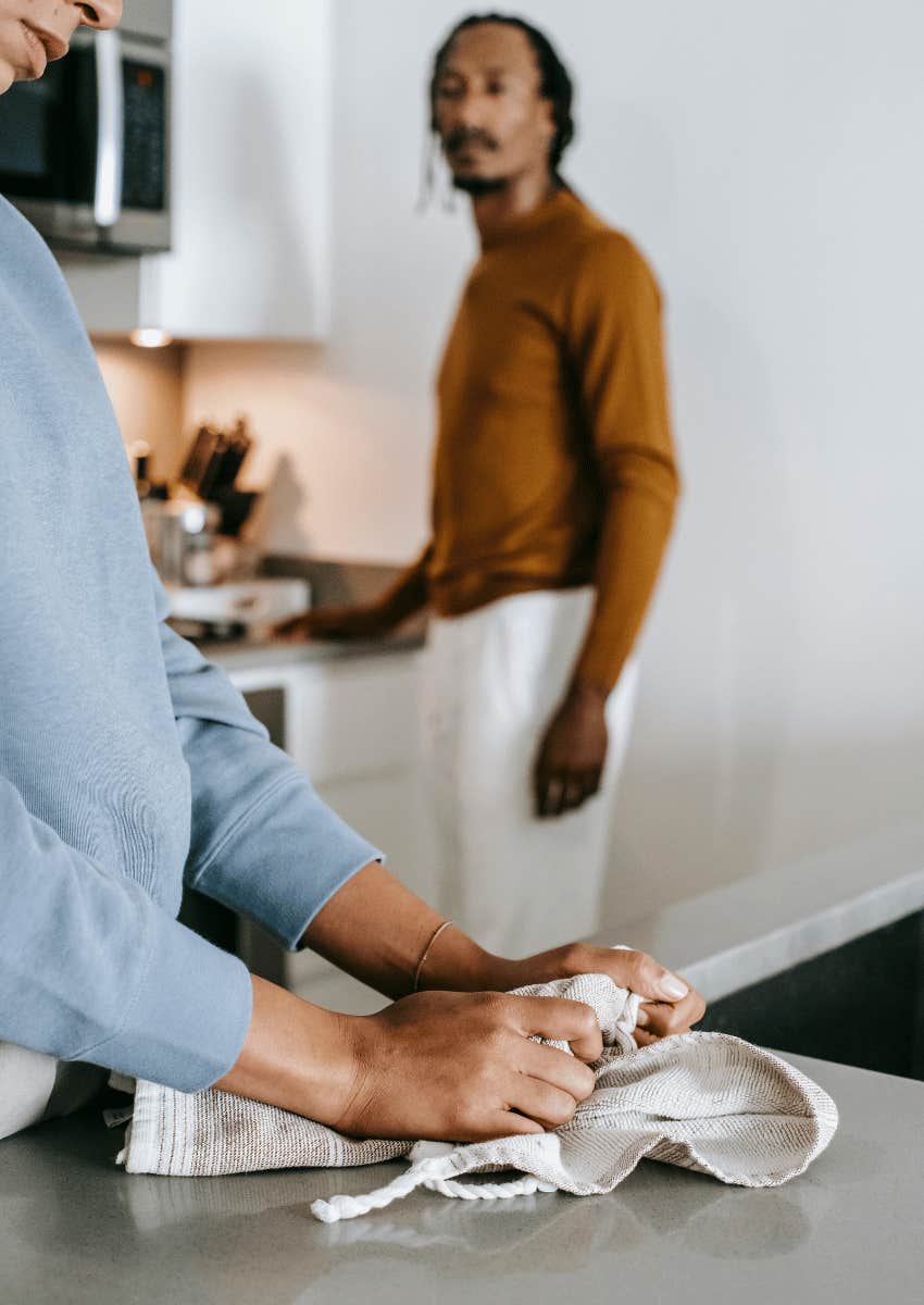 tense couple standing in a kitchen