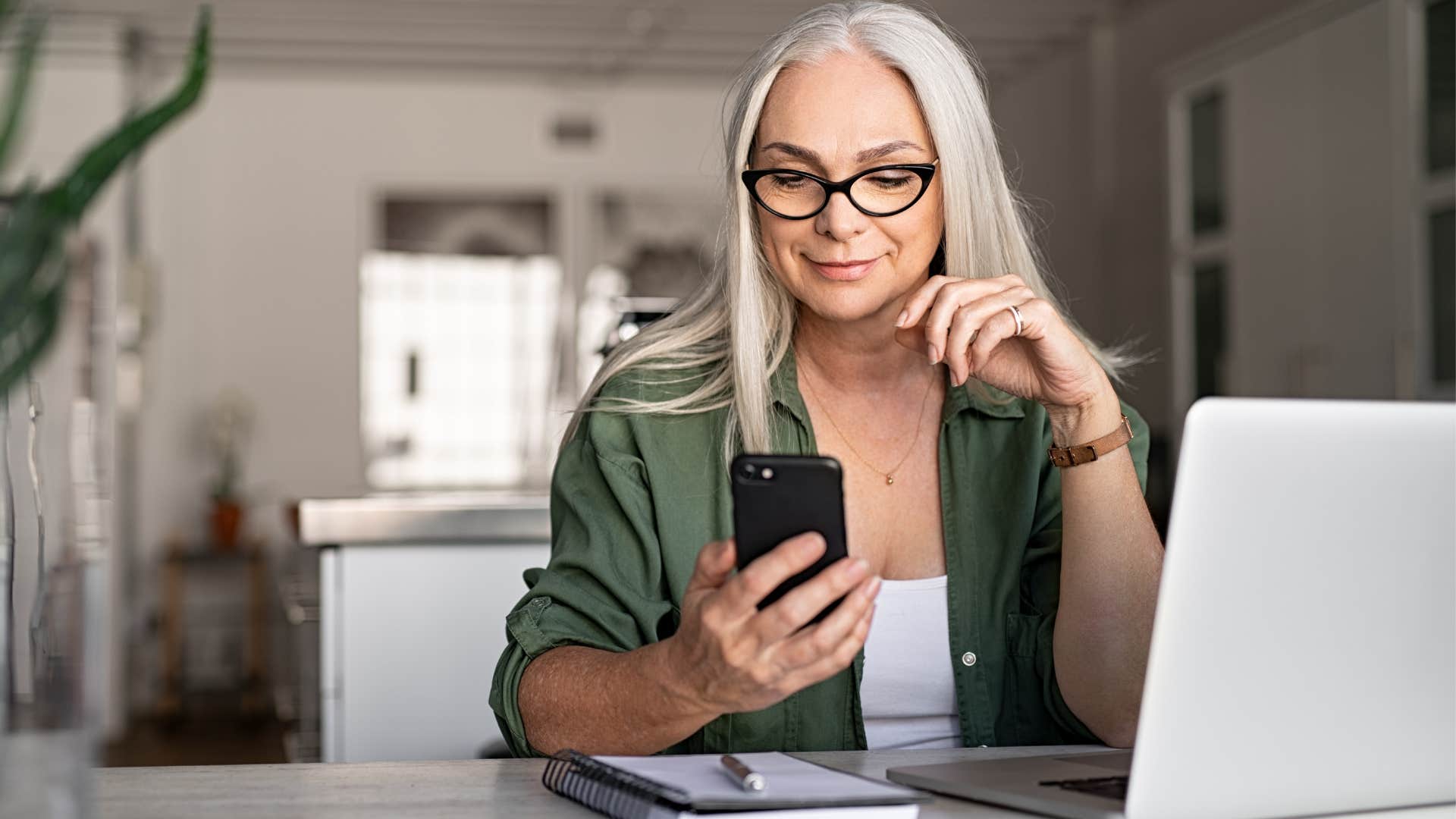 Older woman looking at her cell phone. 