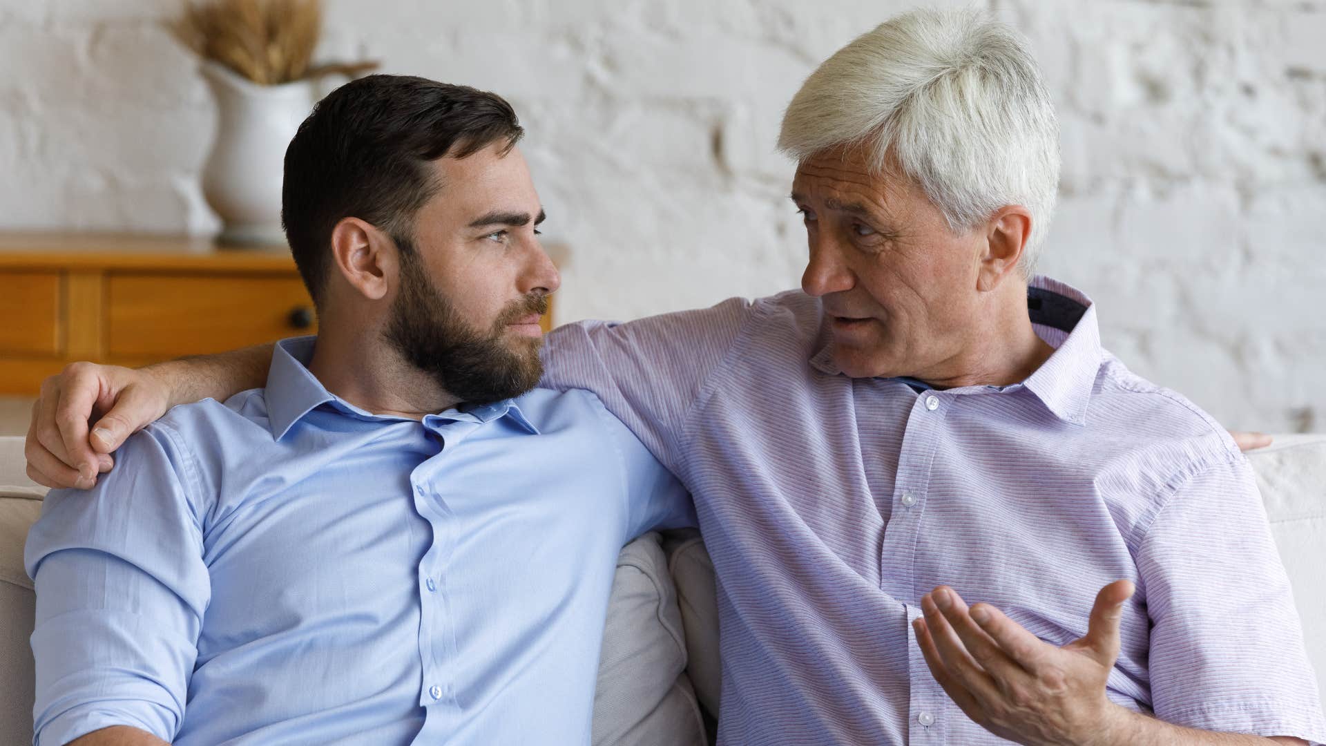 Dad and adult son talking.