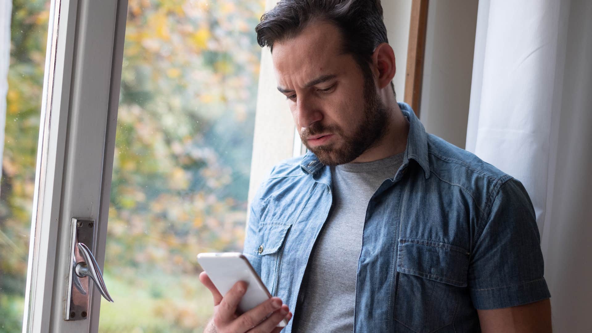 Gen X man looking at his phone