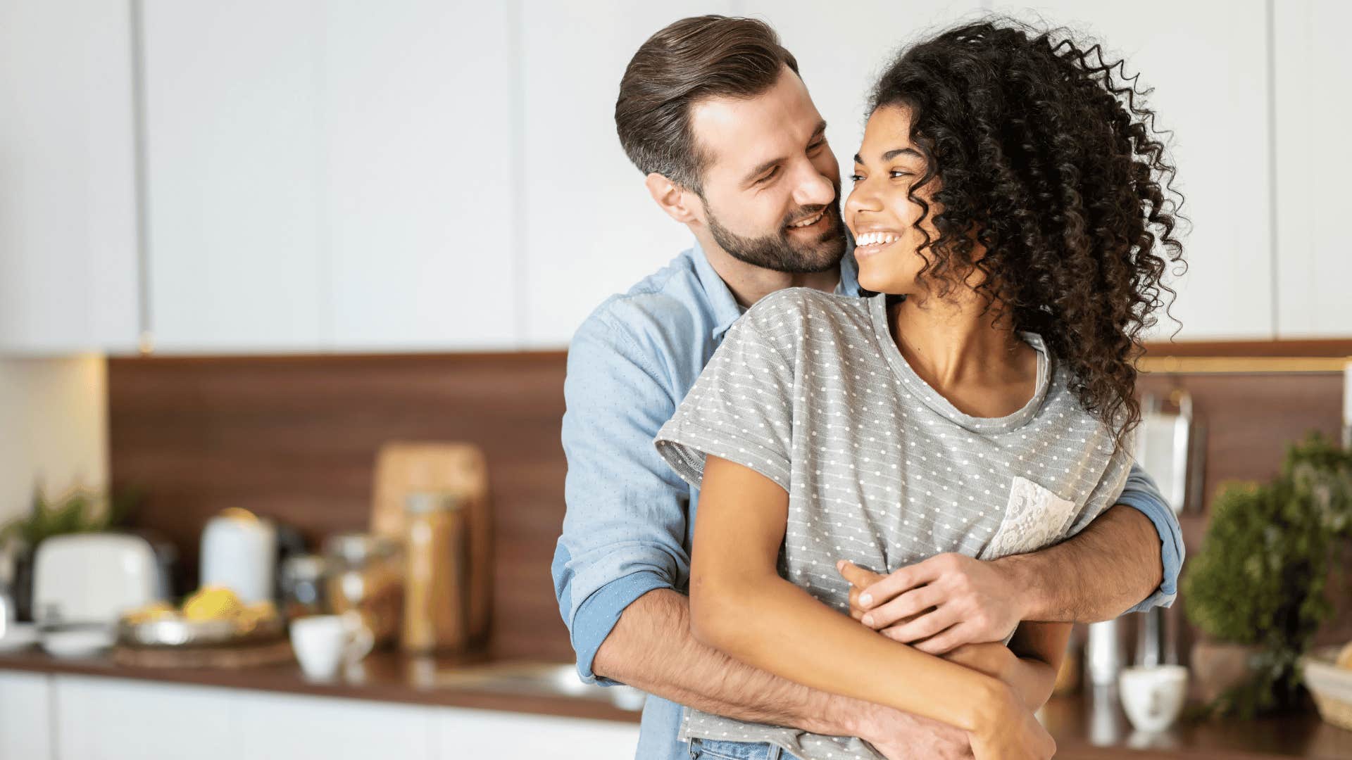 couple embracing in kitchen