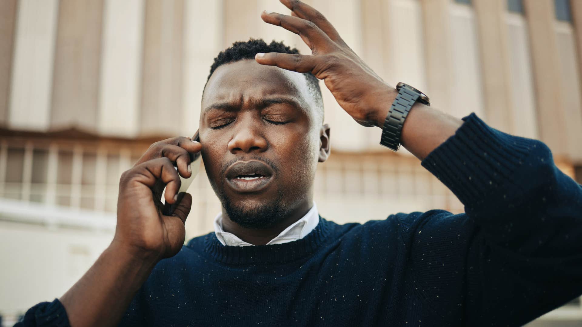 Man looking shocked and annoyed on the phone