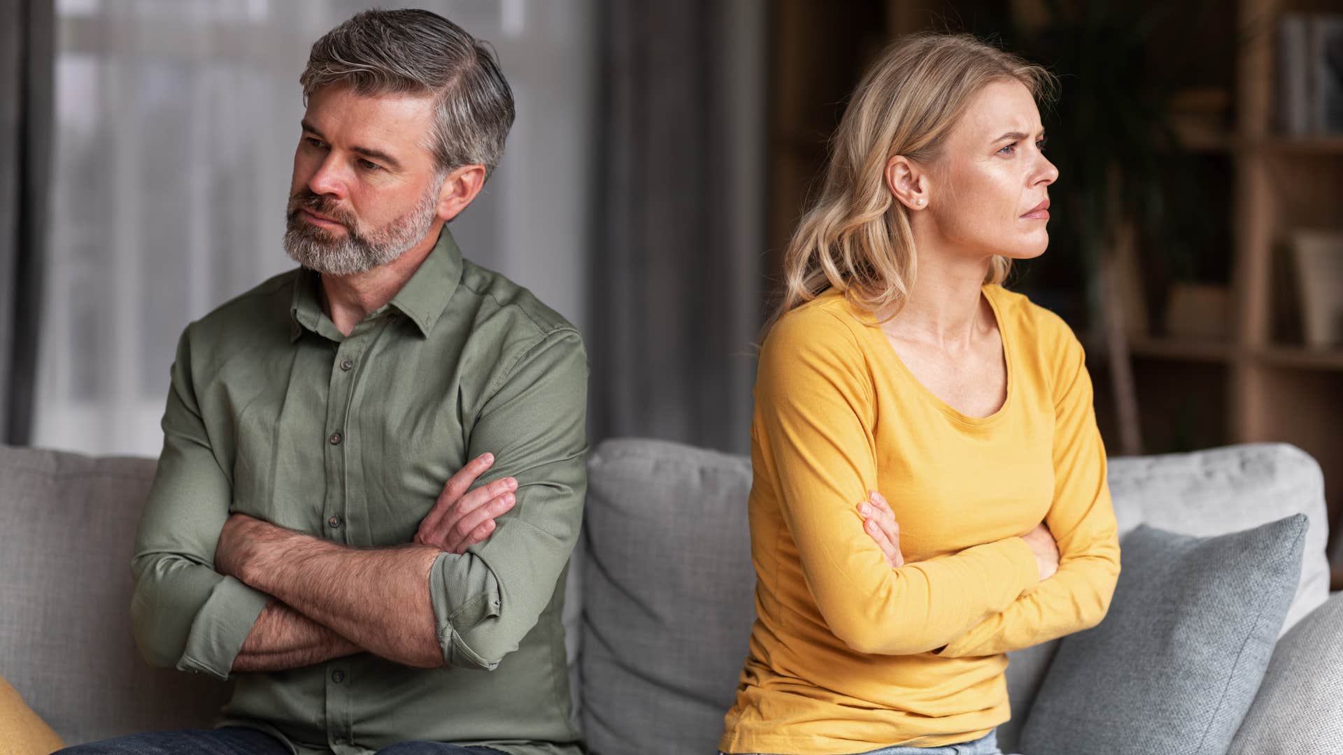 Couple sitting back-to-back angry at each other