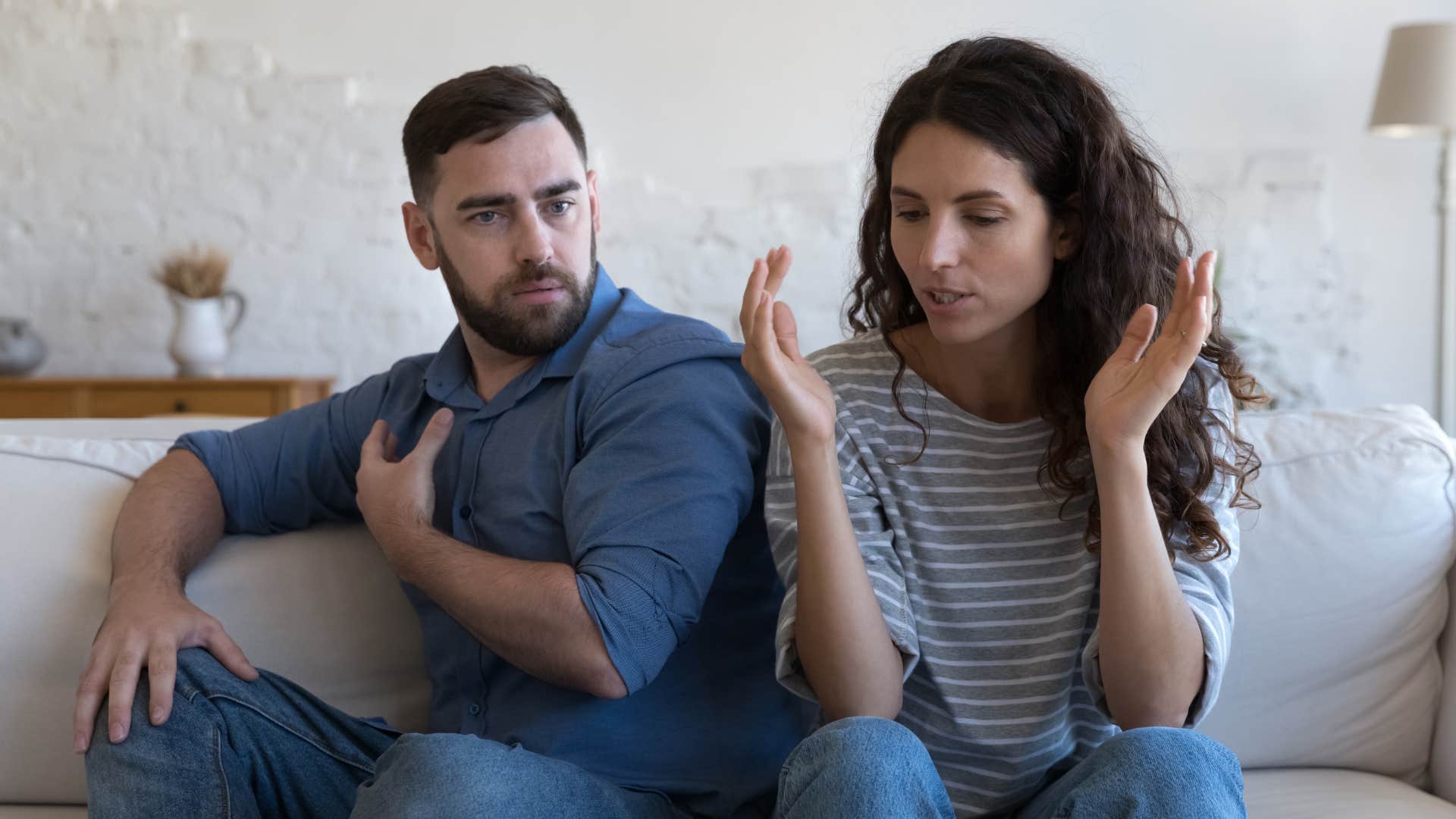 Couple arguing on the couch.