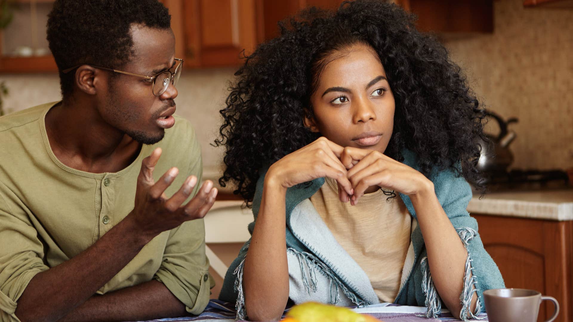 Woman looking annoyed sitting next to her husband.