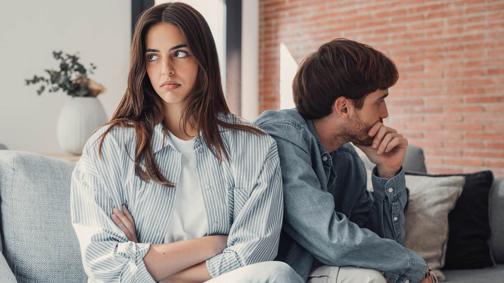 Woman looking annoyed turned away from her husband.