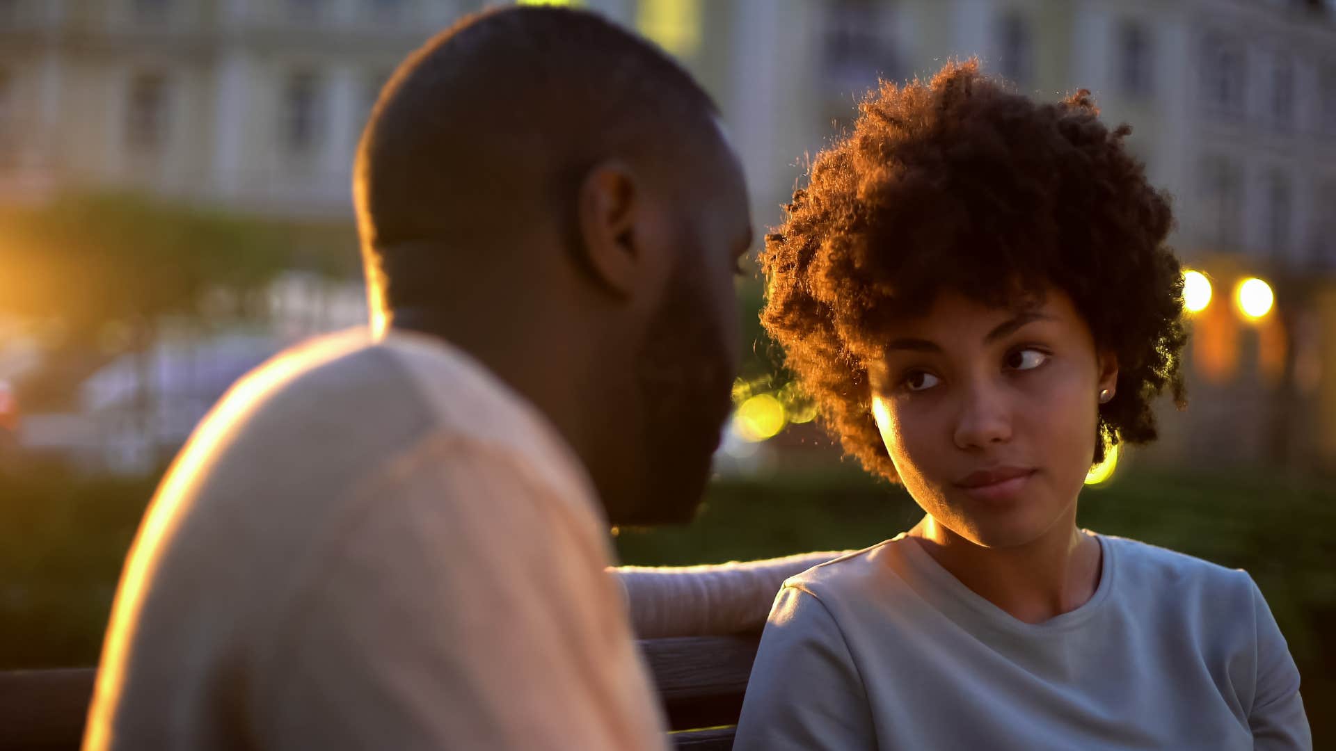 Woman looking annoyed listening to her partner talk.