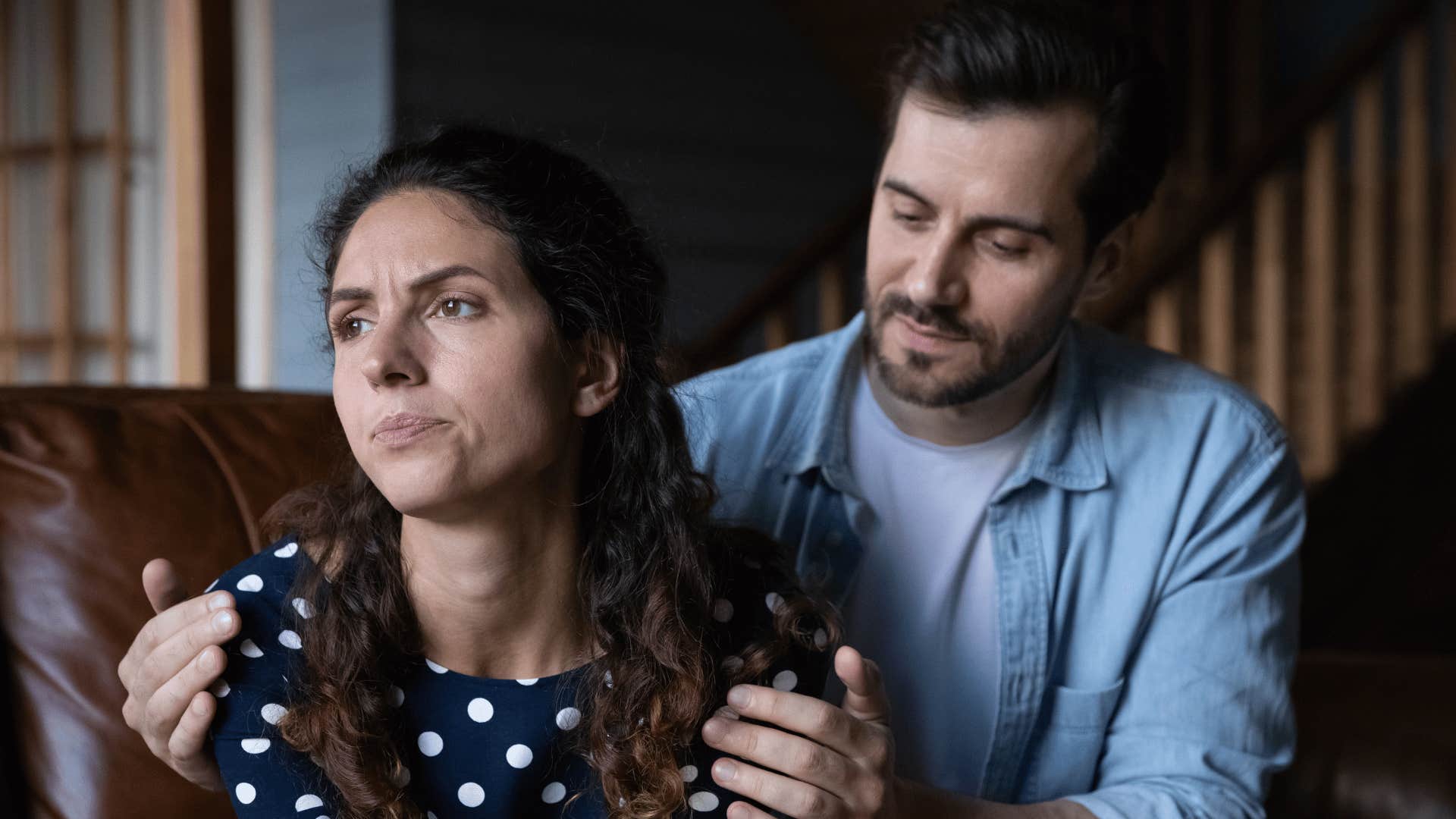 man comforting annoyed woman 