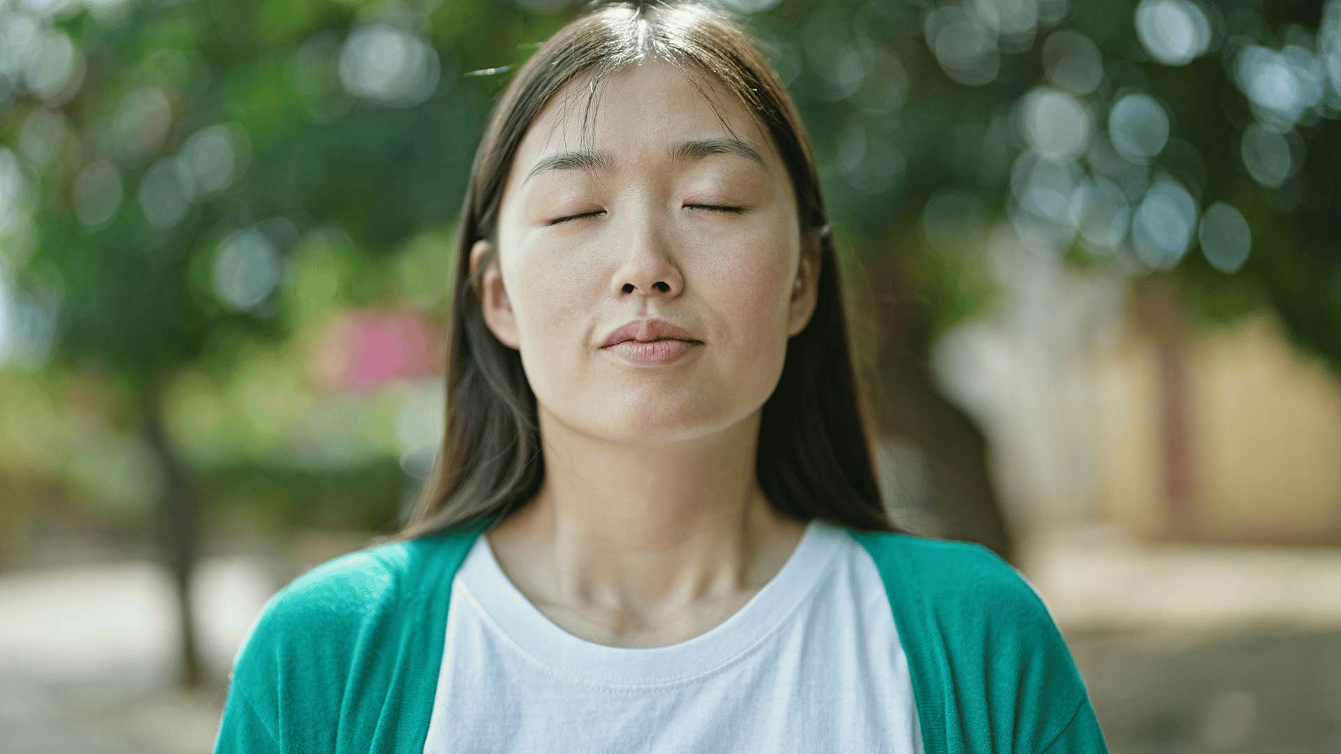 woman deep breathing outside 