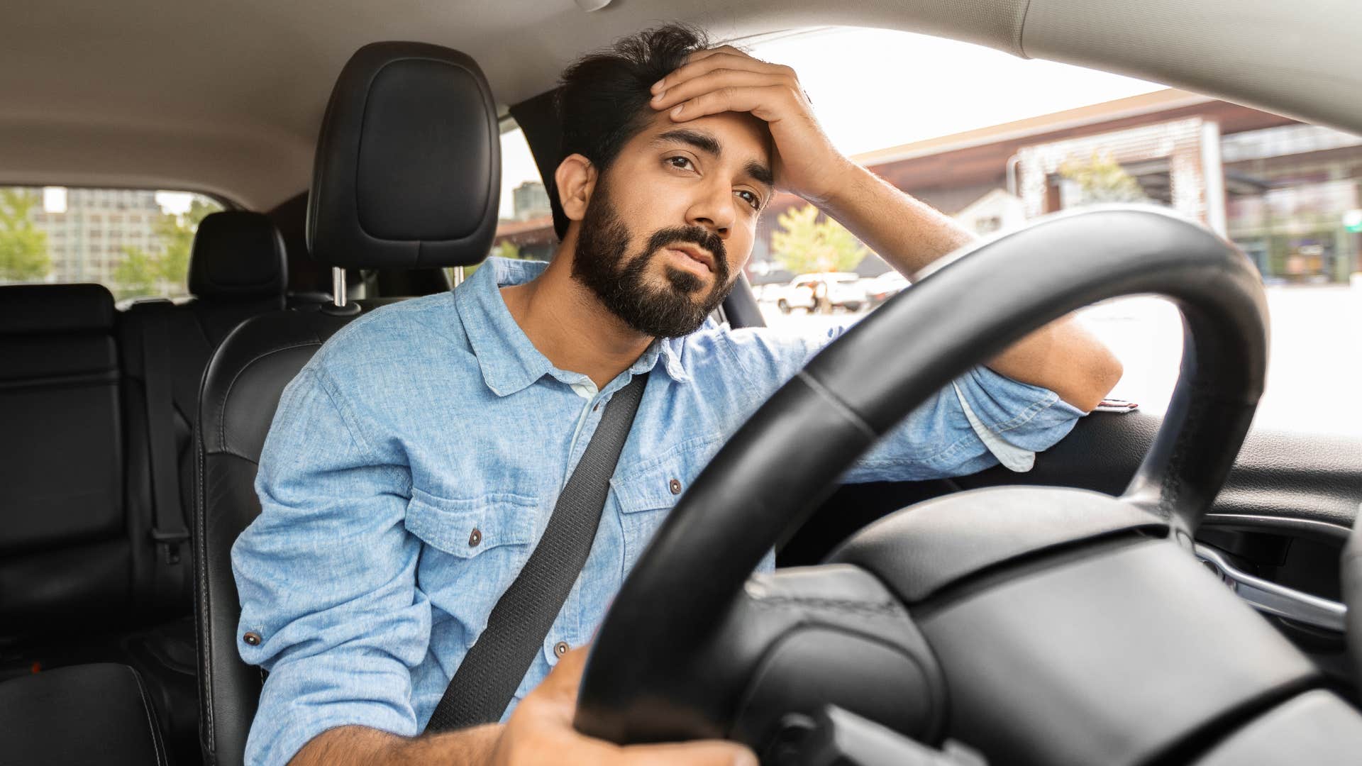 Man looking annoyed driving his car.