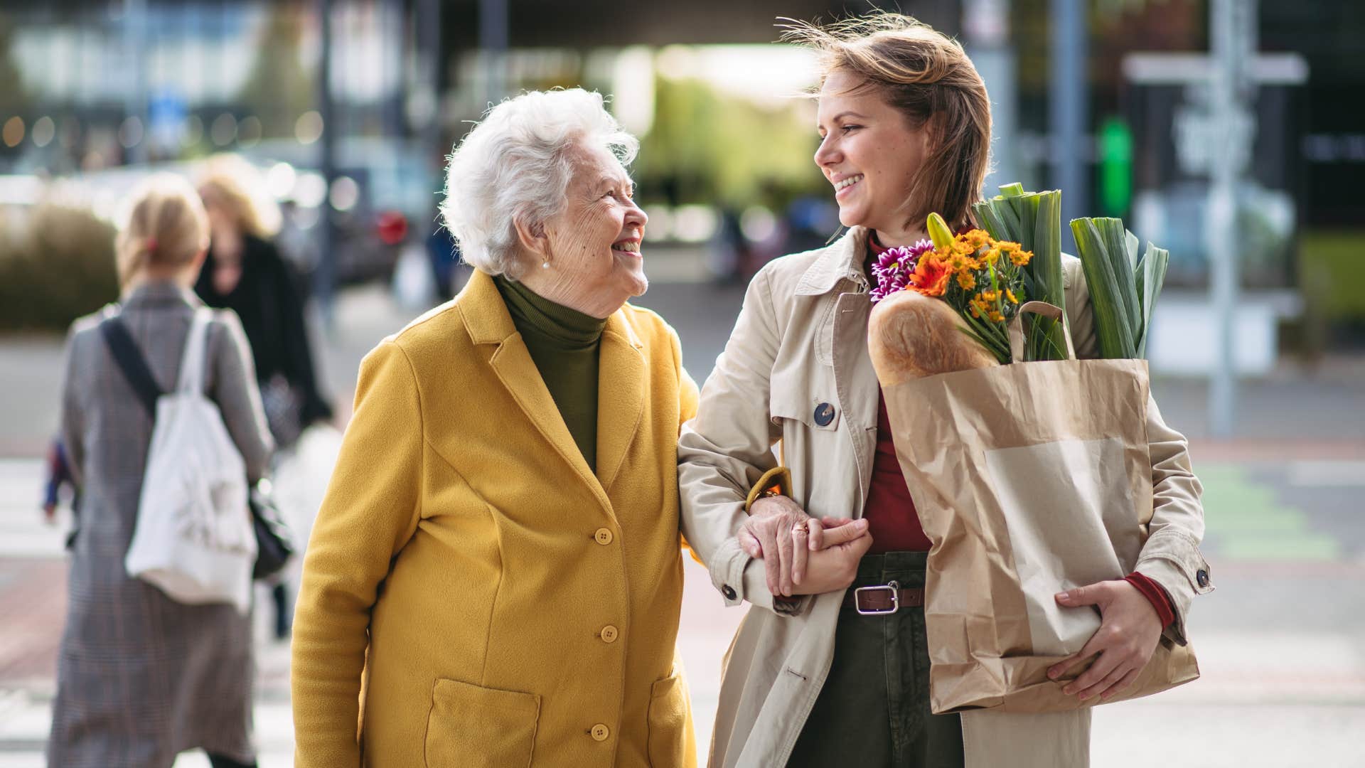 Old woman walking with her daughter in the grocery store.