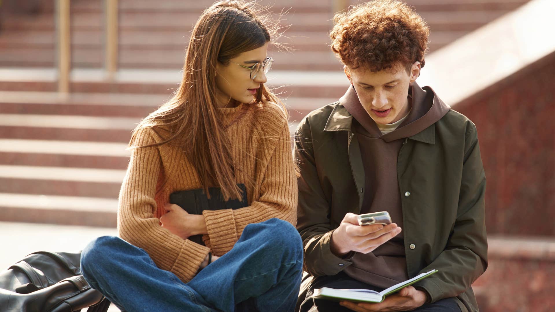 Young man and woman sitting together and talking.