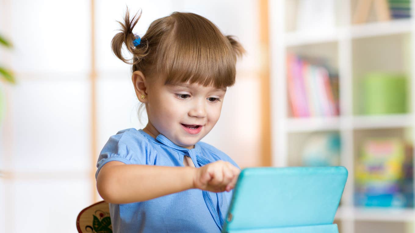 Cute little girl using iPad