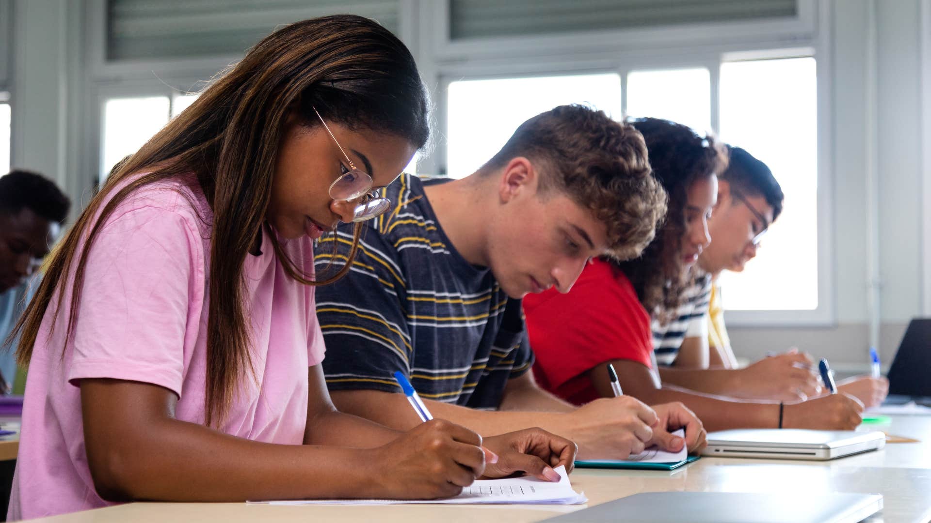 Older students writing at their desks