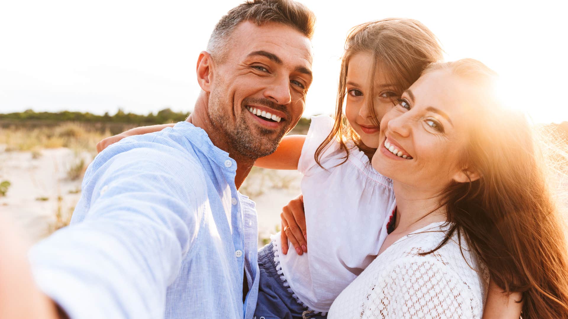 Family smiling together on a beach