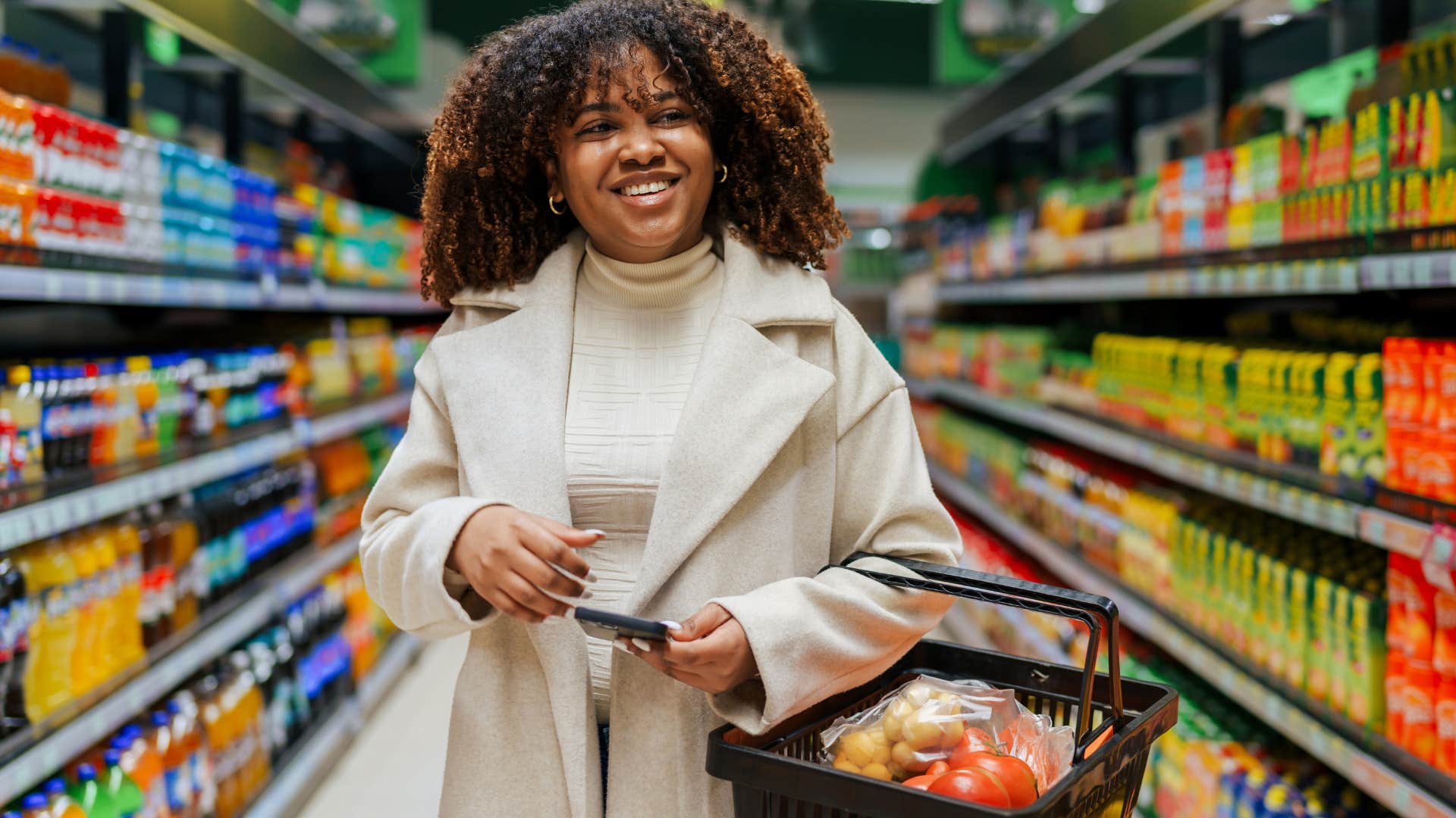 Woman smiling while walking through the grocery store