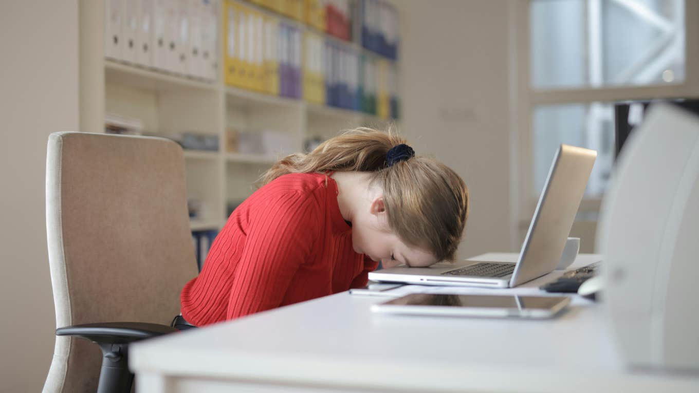 Woman with head on laptop