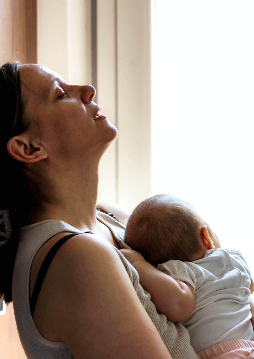 tired mom holding a newborn