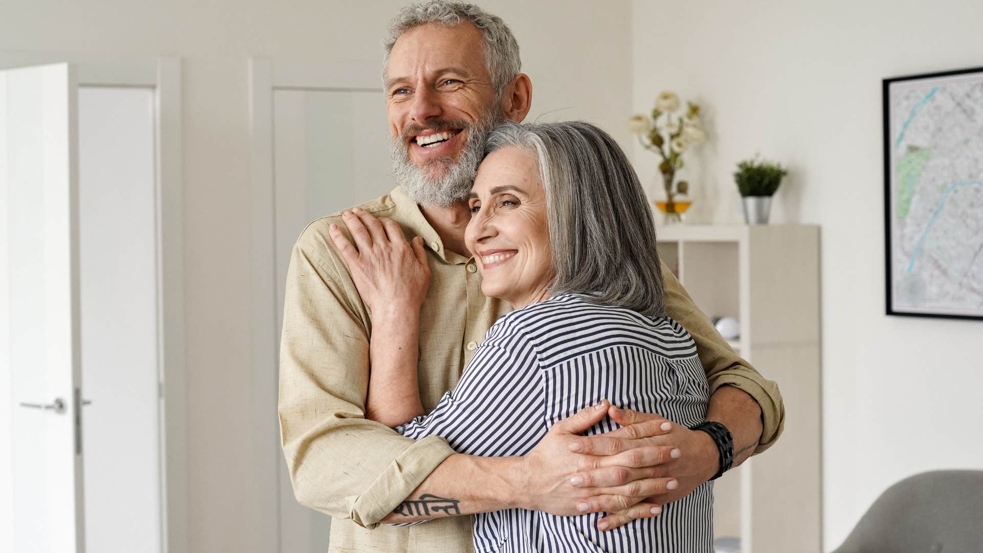 Older couple hugging each other.