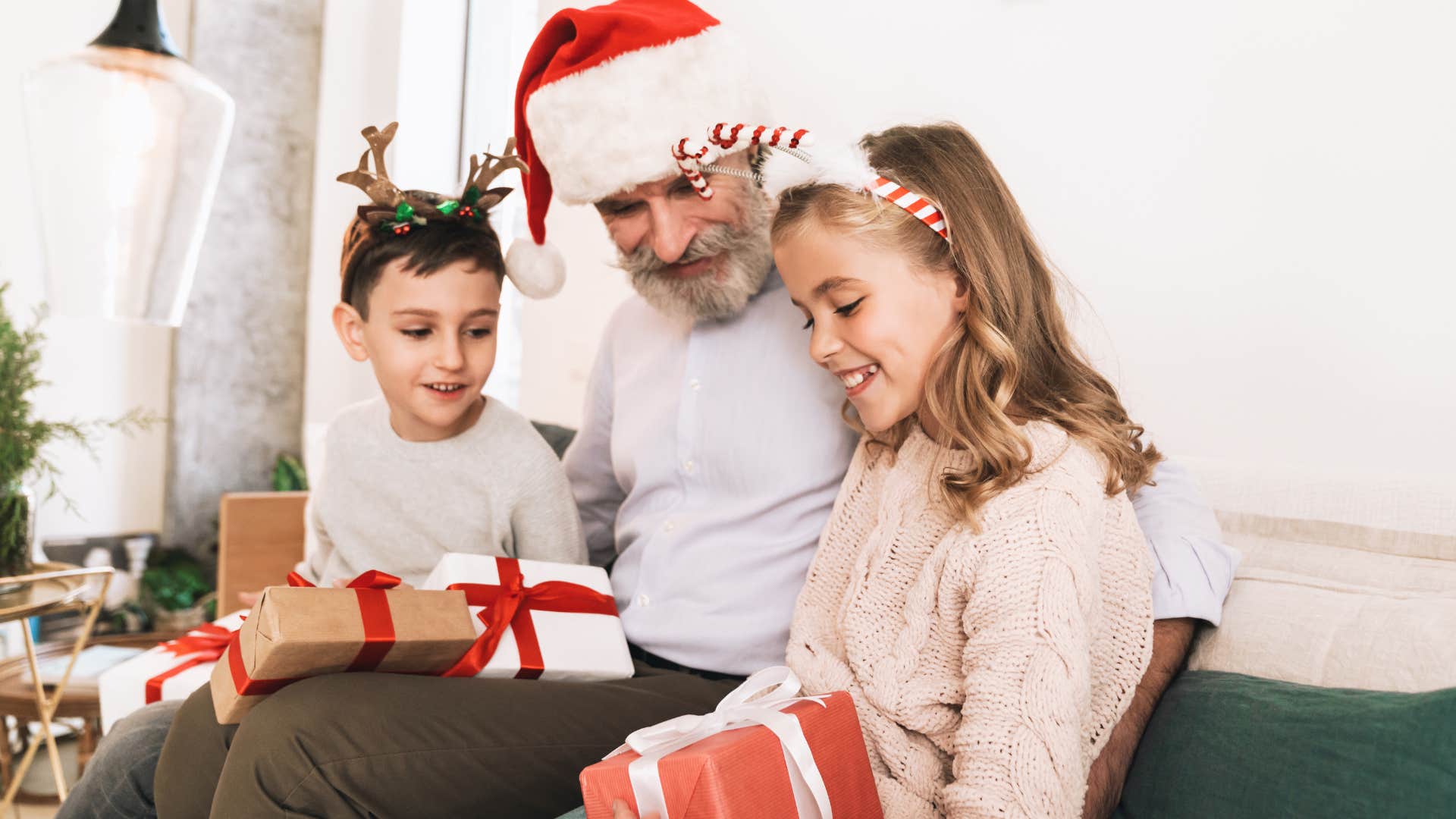 Grandfather smiling in between his two grandkids.