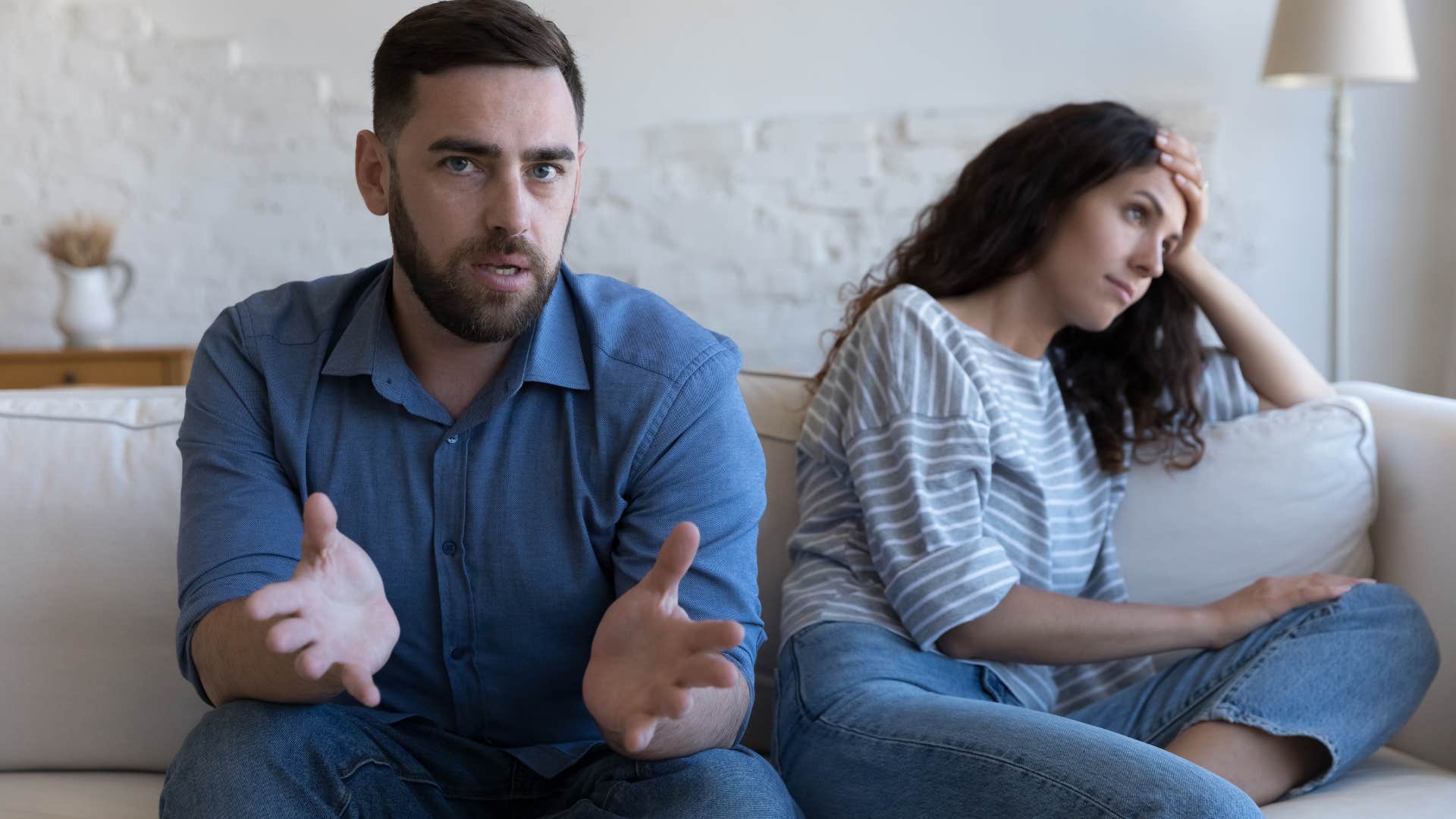 emotionally stunted man looking defensive next to his girlfriend