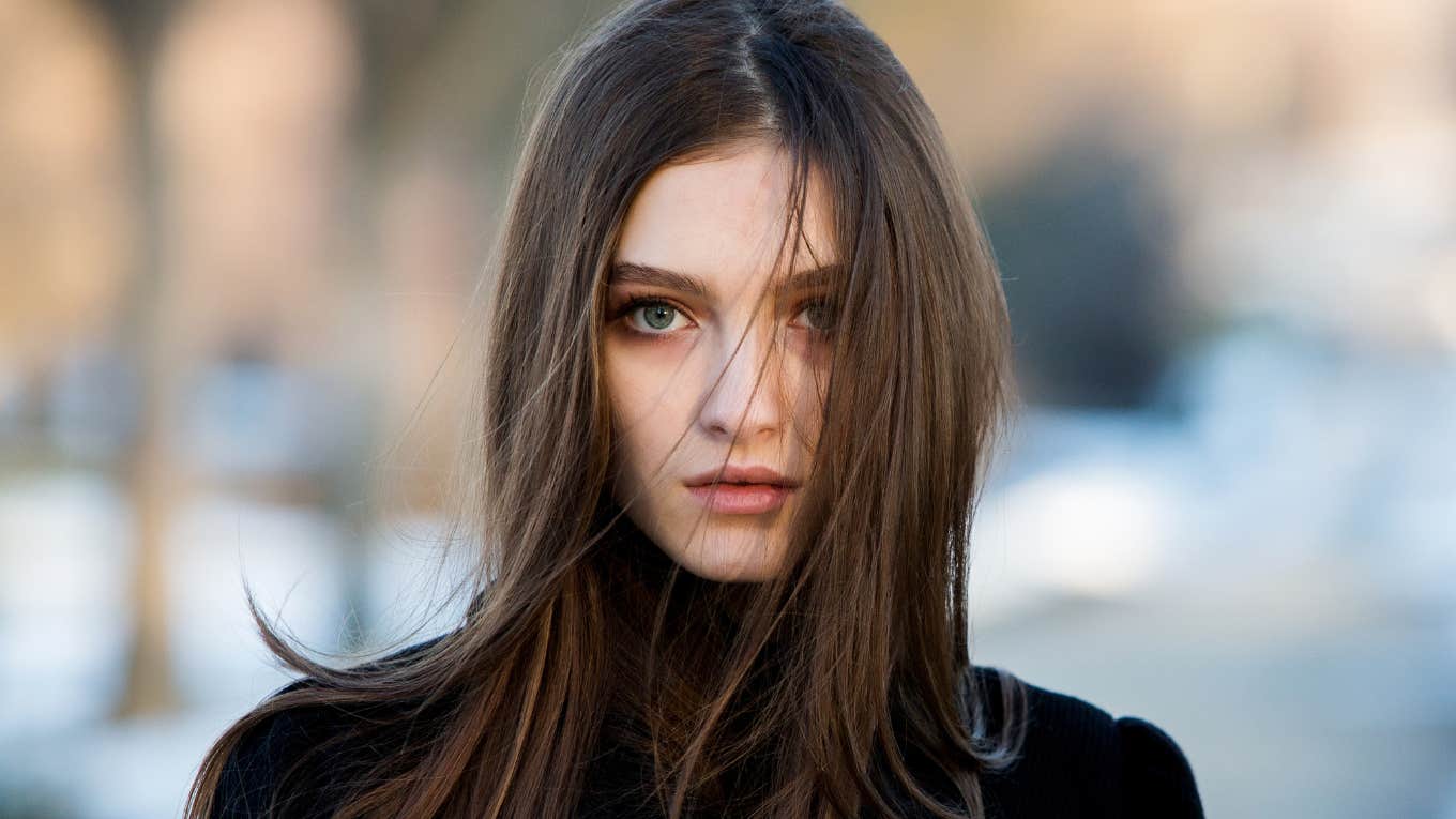 sad young woman standing outside