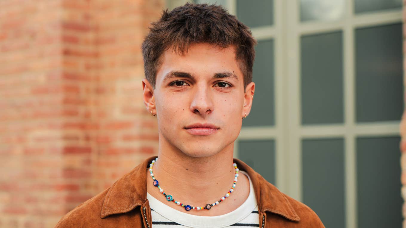 naive young man wearing necklace