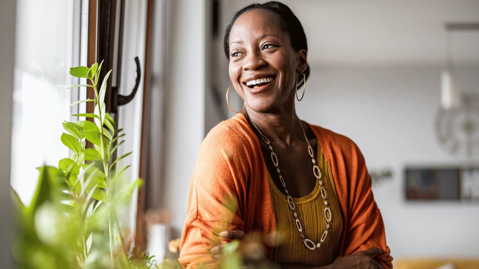 woman smiling while looking out the window