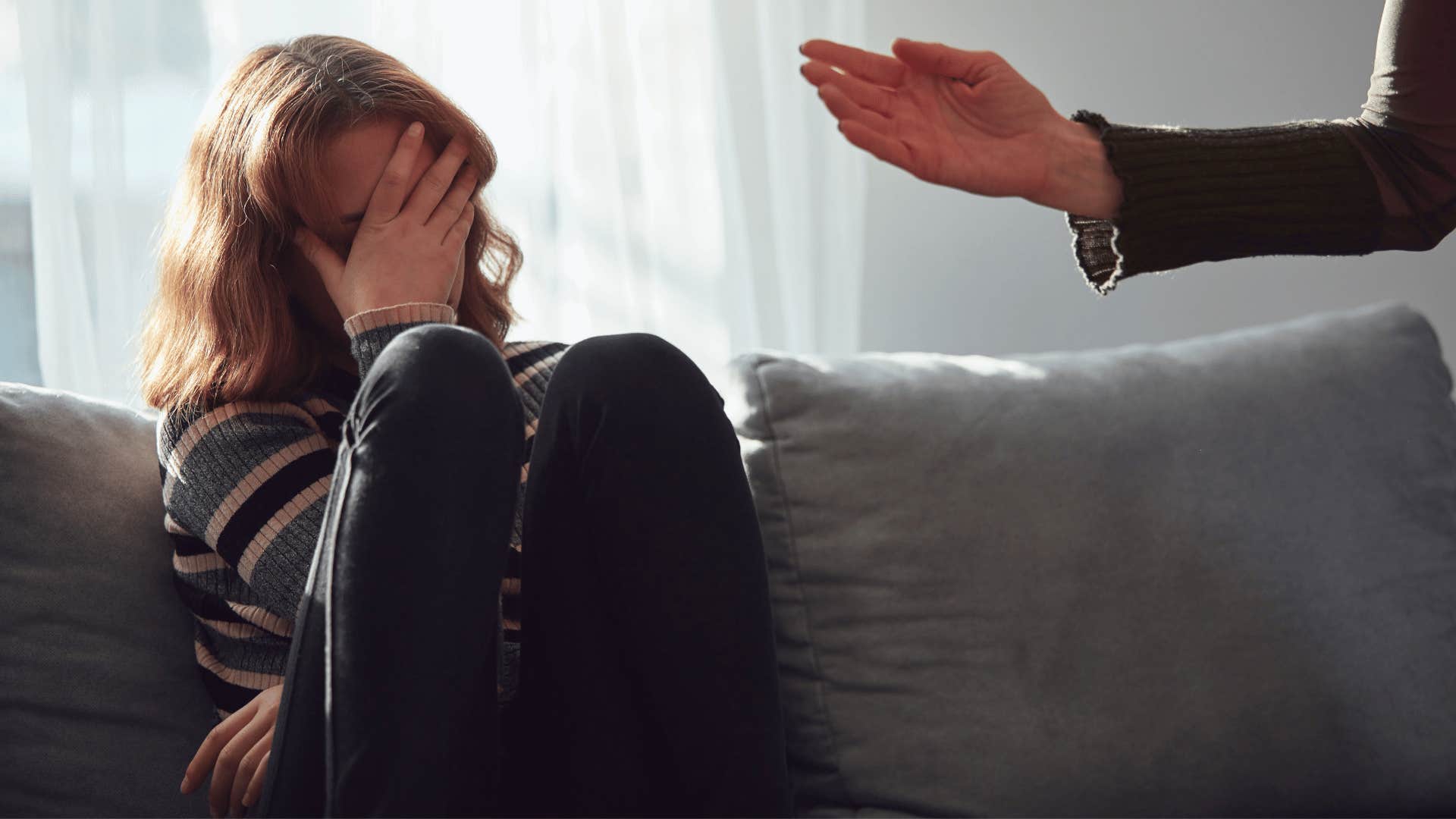 daughter upset while mother scolds her 