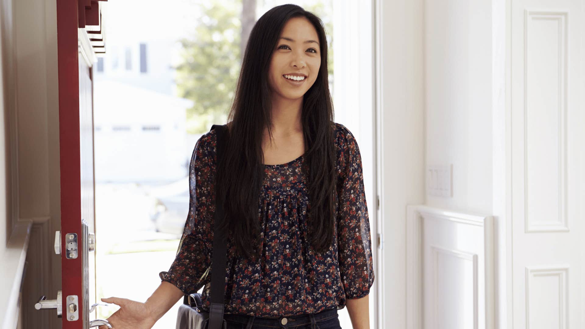 Woman opens door and smiles trustlingly