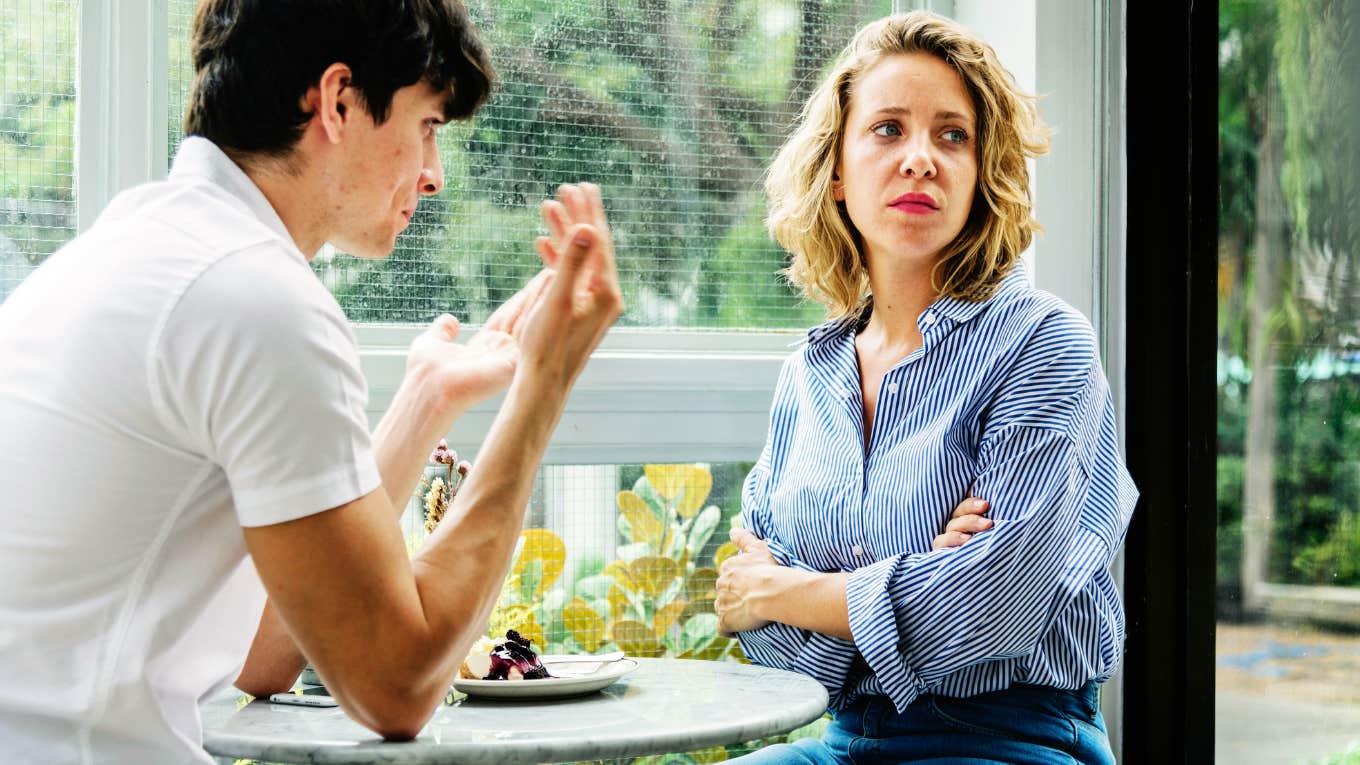 Frustrated woman sitting in front of husband.