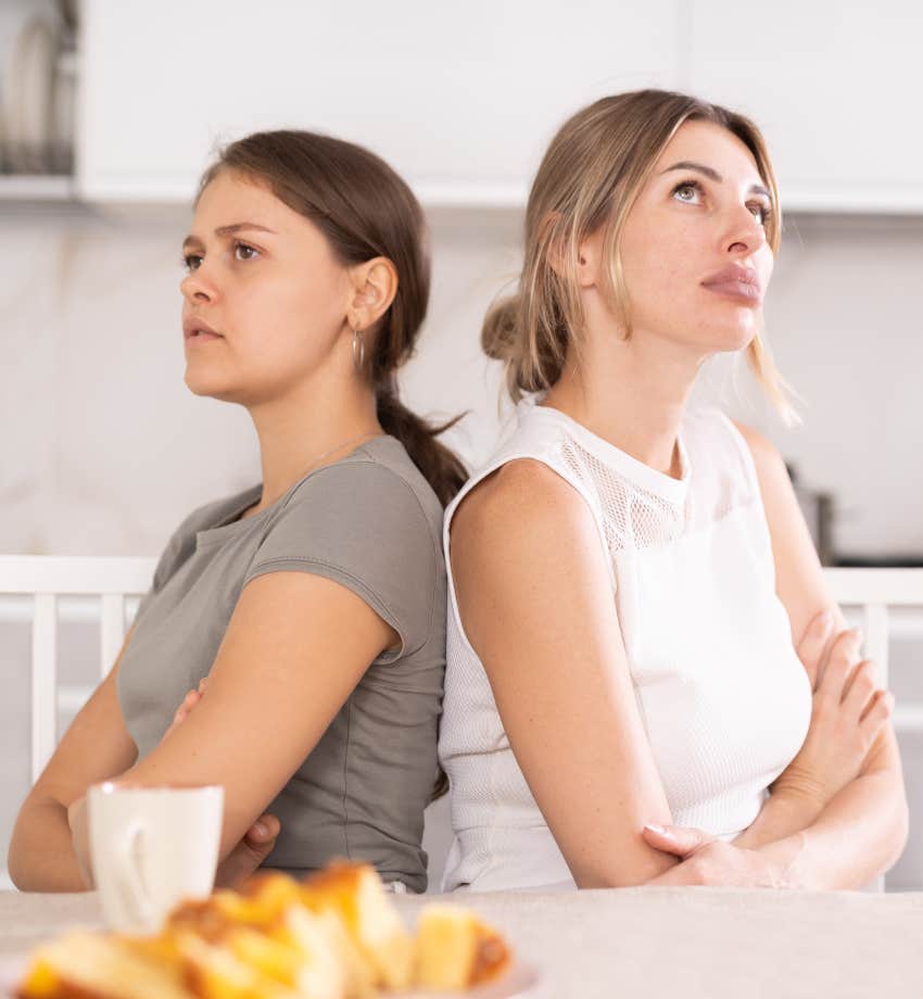 two women arguing, sitting facing away from each other