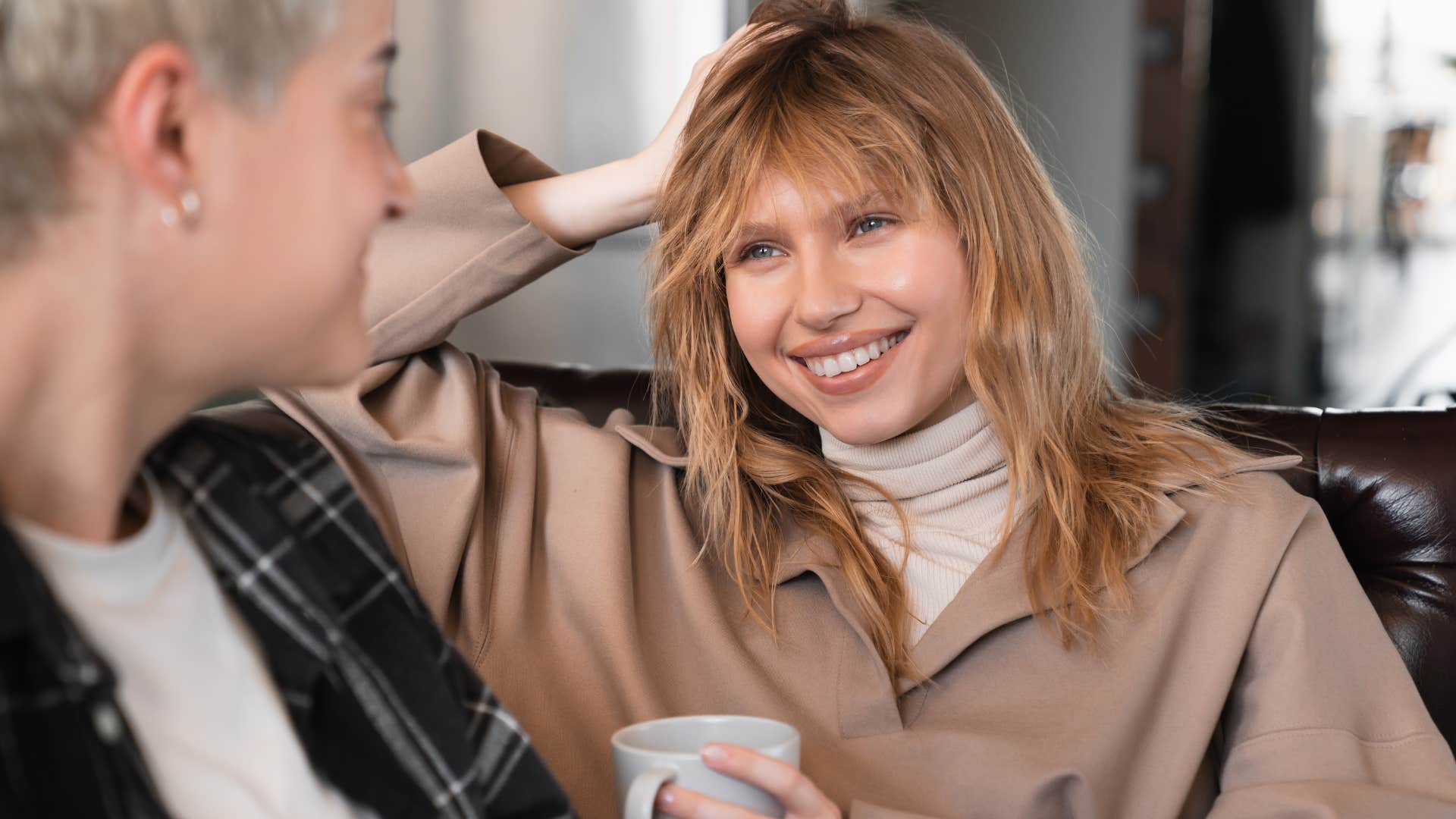 Woman smiling while talking to her partner on the couch