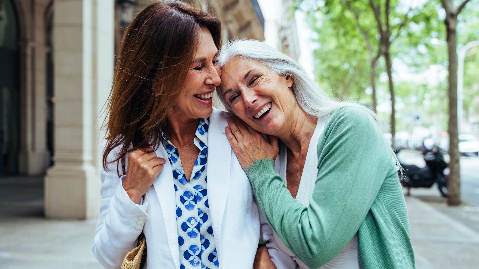 Older female friends smiling and laughing together