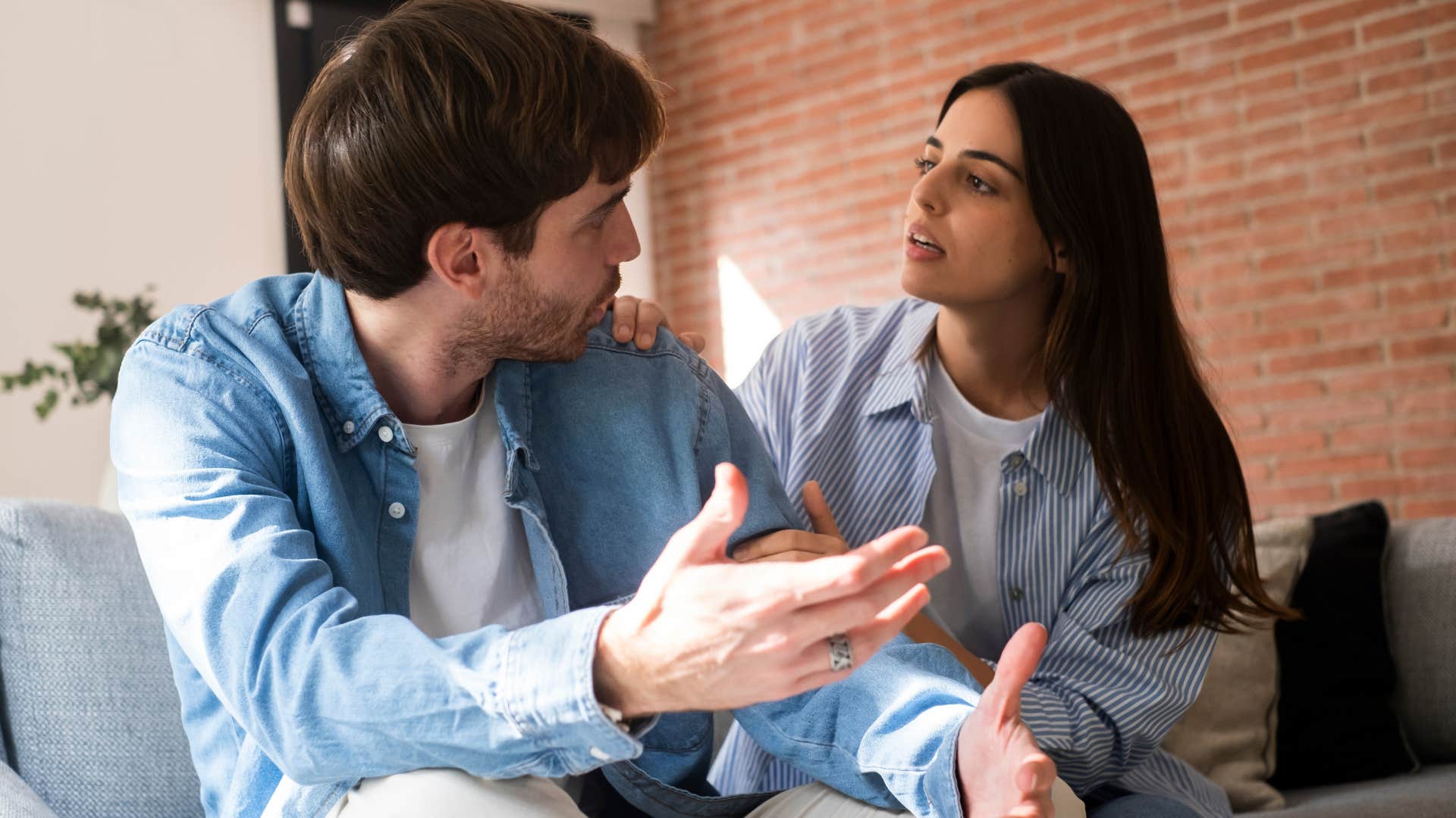 Woman looking serious talking to her upset partner