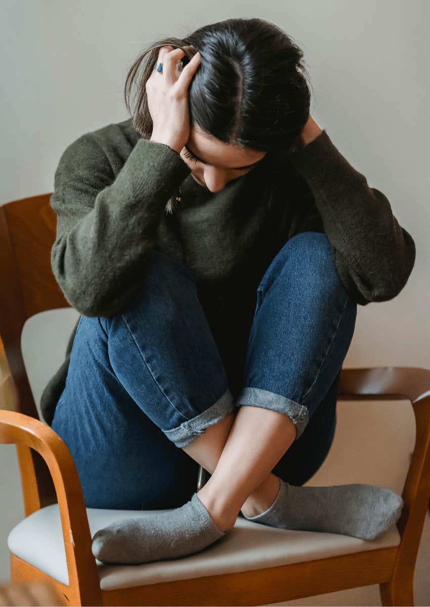 upset woman holding her head and her hands