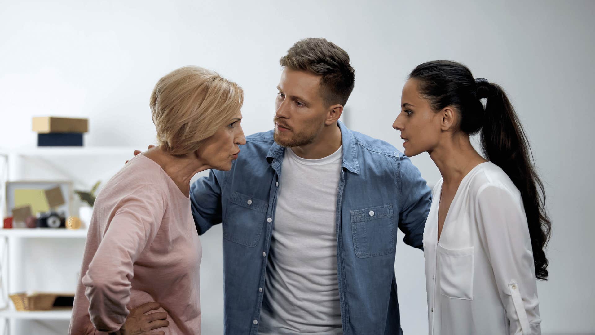 man mediating an argument between his wife and mother