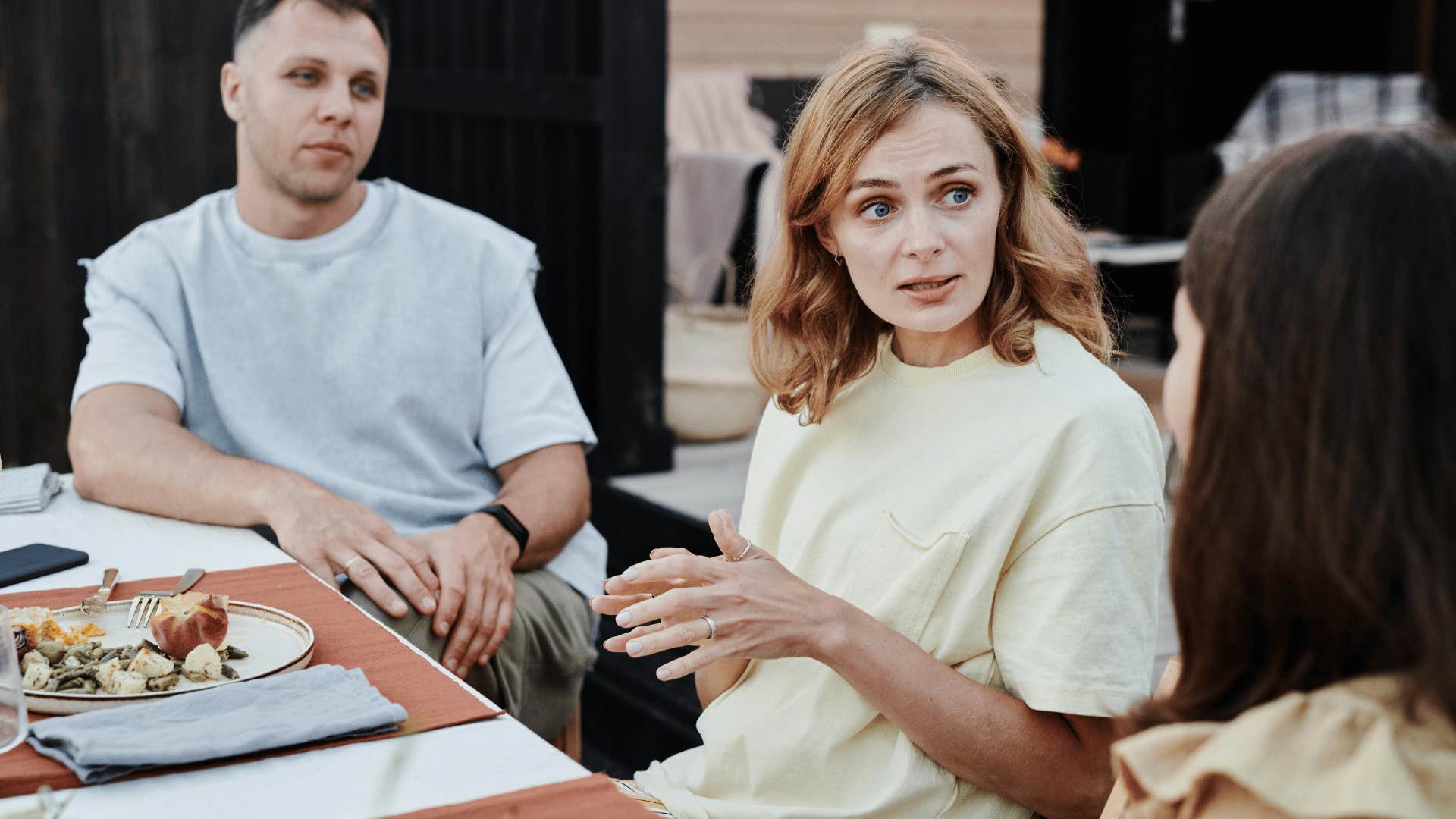 woman talking sternly during a meal