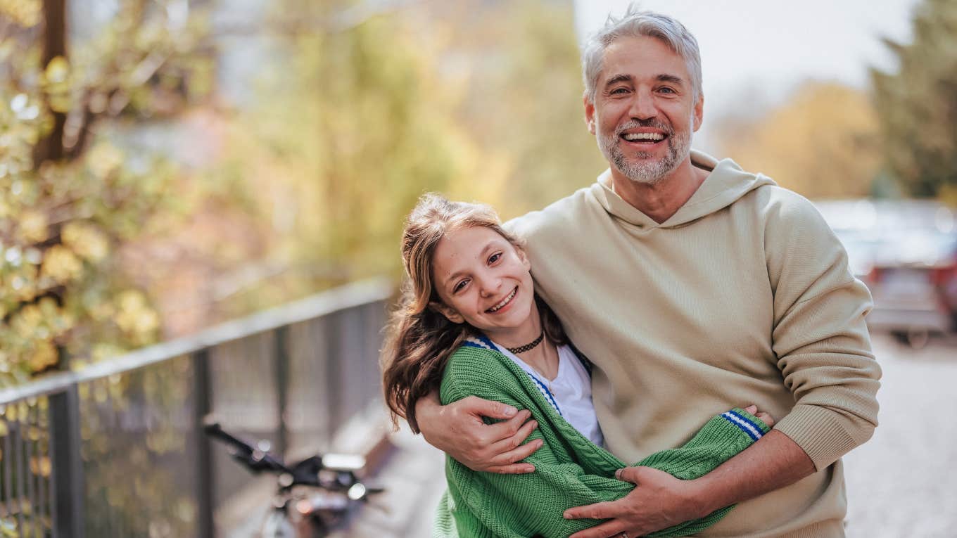 smiling dad and teen daughter