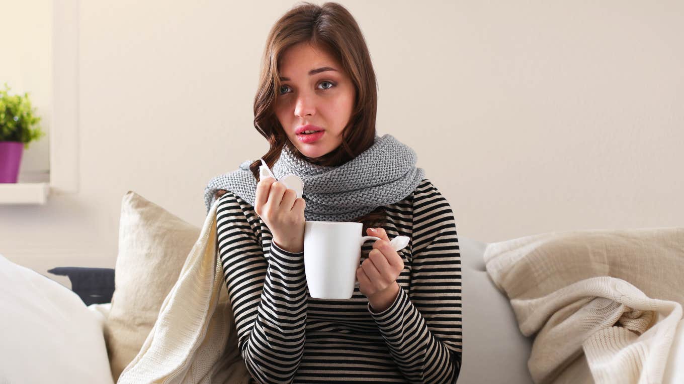 Wife sick on the couch wishing husband wouldn't disappear