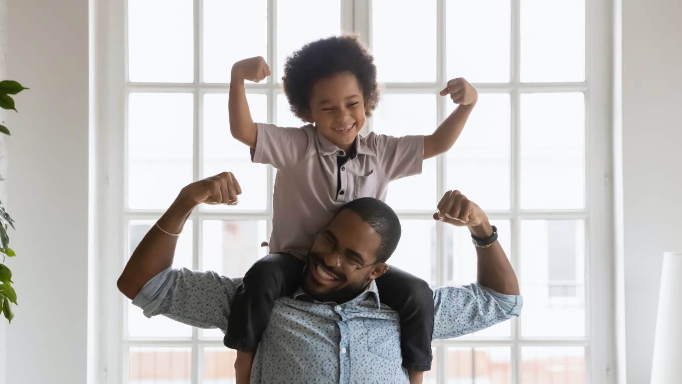 Dad and toddler showing off muscles