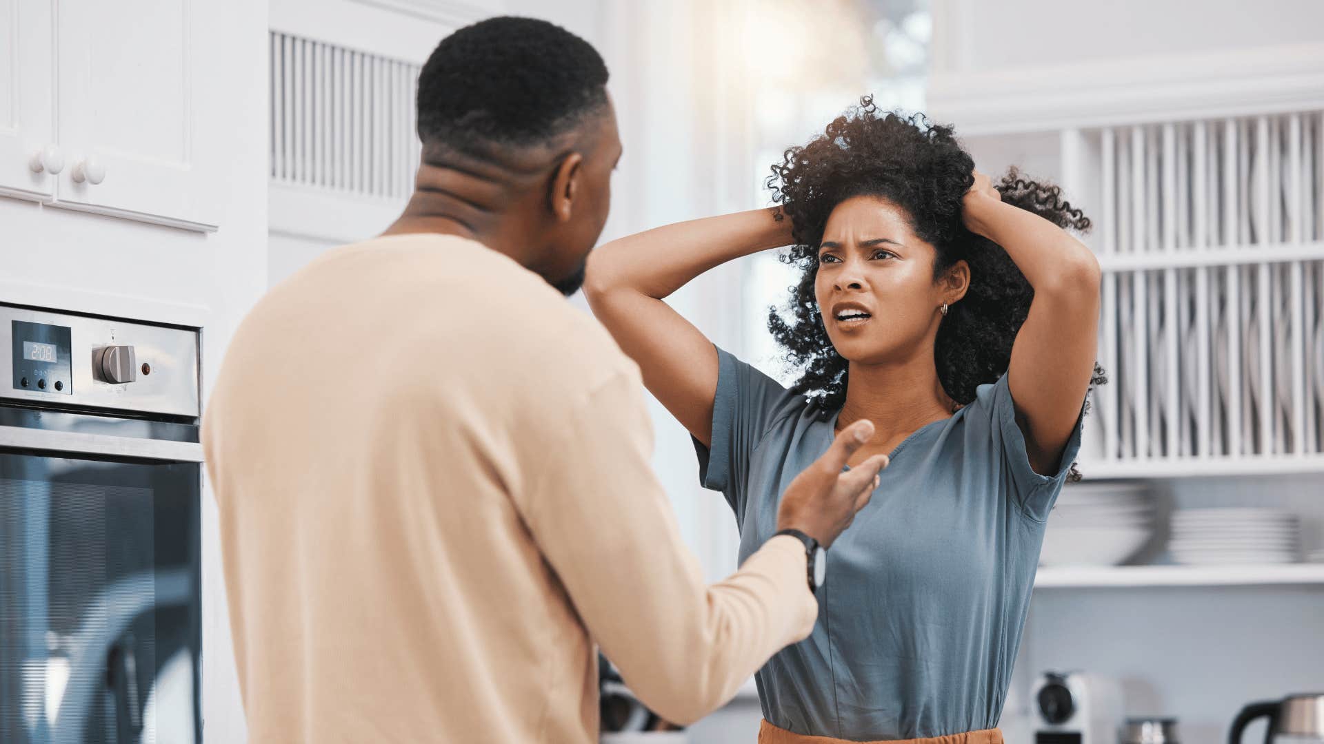 Couples argues, she grabs her hair and looks frustrated