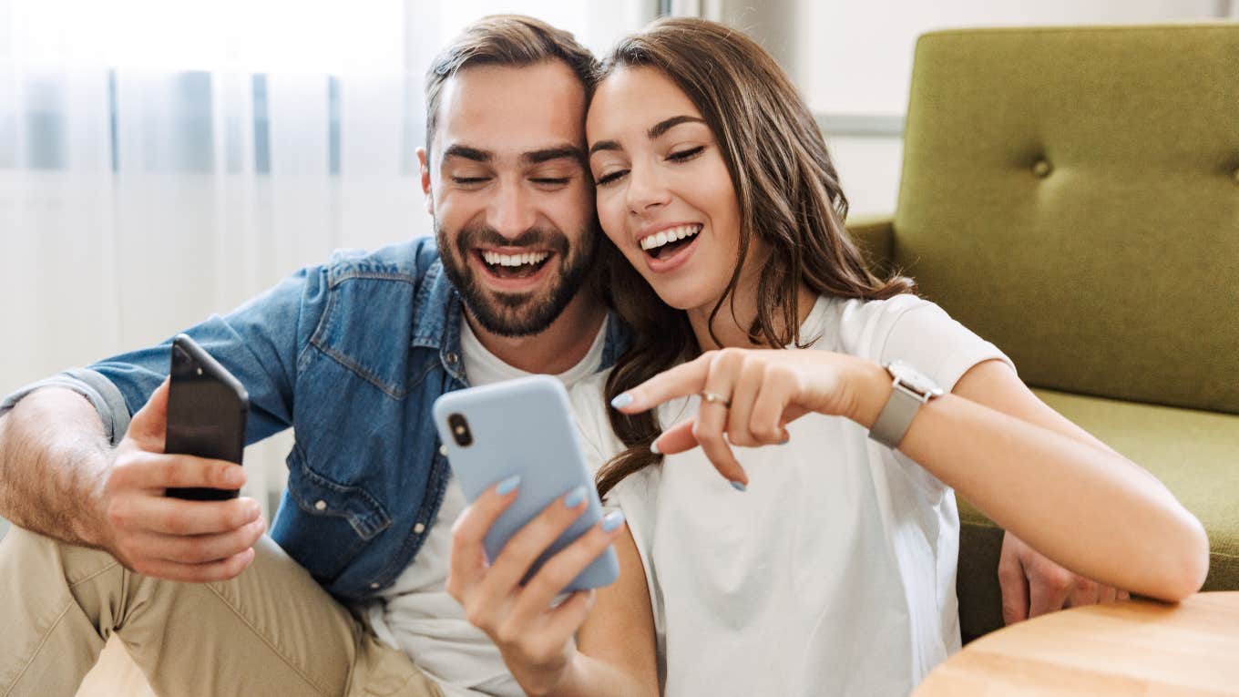 A woman and a man looking at memes on their phones