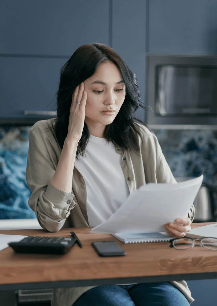 woman at a high counter working on a financial plan