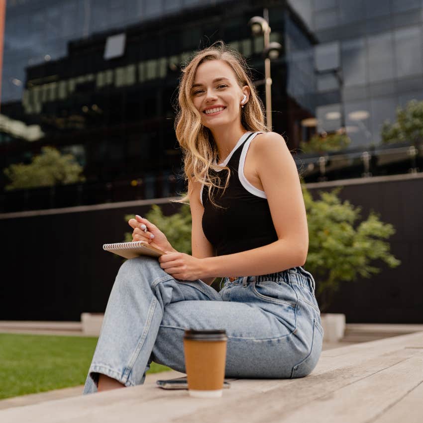 Woman carrying a small notebook to improve her life