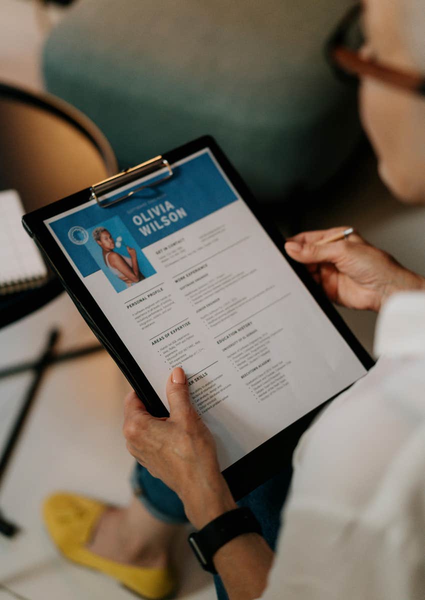 woman holding a resume on a clipboard