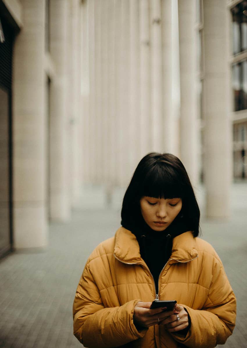 woman outside looking at phone