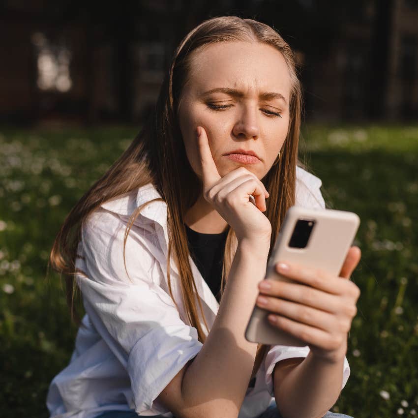 Woman reading the condescending updates her friend sent her fiancé