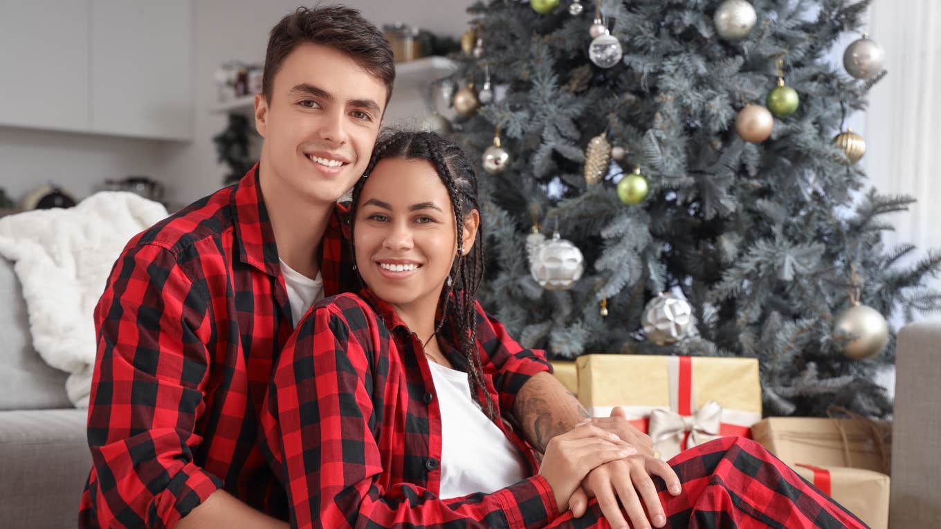 Couple wearing matching holiday pajamas